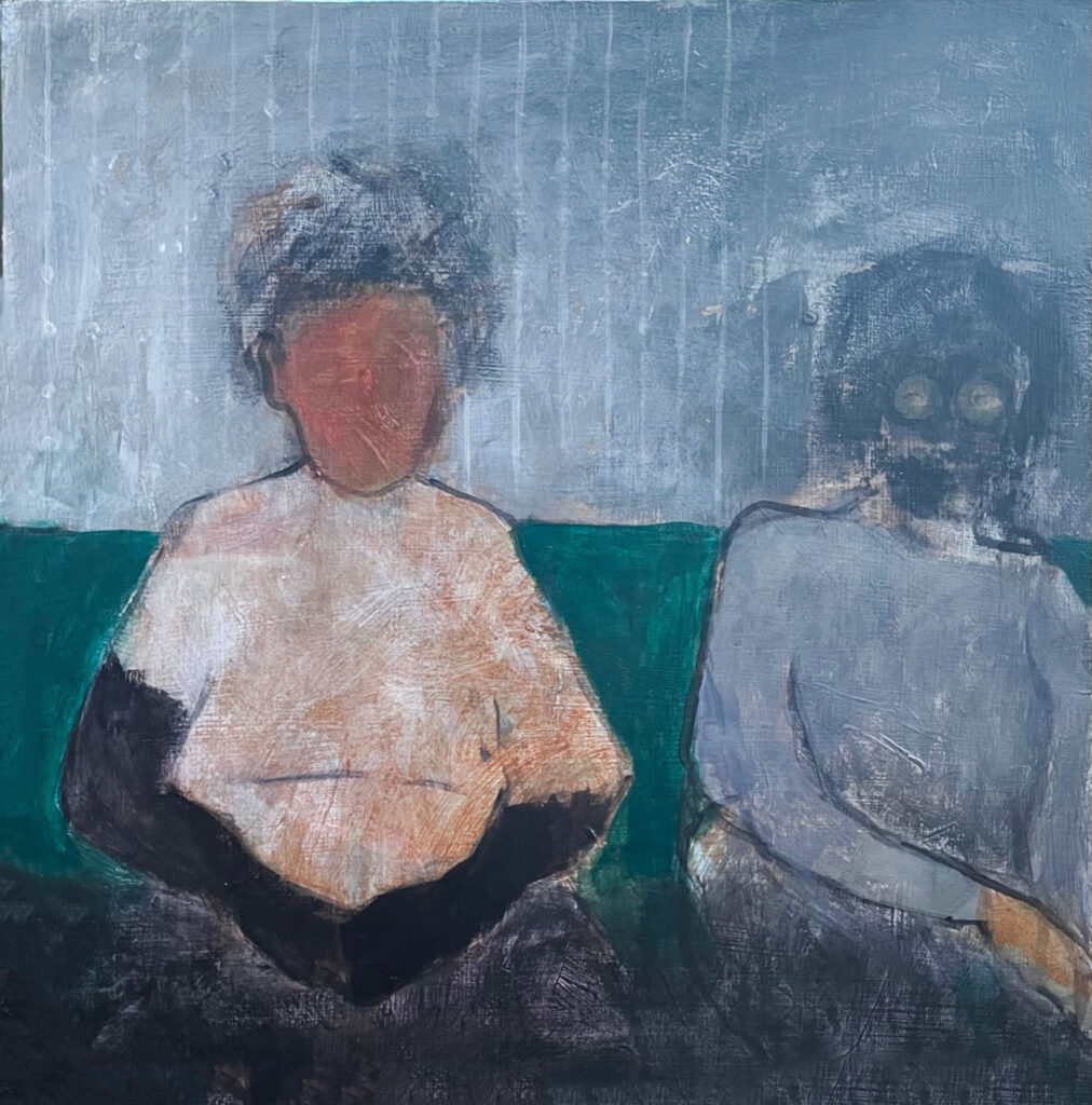 two persons sitting on sofa